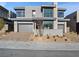 Contemporary two-story home showcasing modern design elements and a well-maintained front yard at 4880 Argento Peak St, Las Vegas, NV 89135