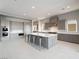 Modern kitchen with stainless steel appliances, large center island, and sleek gray cabinetry at 4880 Argento Peak St, Las Vegas, NV 89135