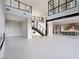 Spacious living room with high ceilings, modern staircase, and open floor plan with tile floors at 4880 Argento Peak St, Las Vegas, NV 89135