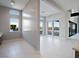 Bright living room with large windows and sliding glass doors, offering plenty of natural light at 4880 Argento Peak St, Las Vegas, NV 89135