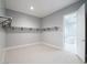 Spacious walk-in closet featuring custom shelving and neutral carpet; bathroom access visible at 4880 Argento Peak St, Las Vegas, NV 89135