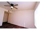 Neutral bedroom featuring a ceiling fan, blank white walls, and window blinds at 5710 E Tropicana Ave # 2152, Las Vegas, NV 89122