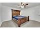 Bedroom with a decorative wooden headboard and a ceiling fan at 5729 Heron Ave, Las Vegas, NV 89107