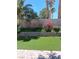 Backyard with manicured artificial lawn and mature landscaping at 5830 Springmist St, North Las Vegas, NV 89031