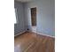 A cozy bedroom featuring hardwood floors and a closet with sliding doors at 5830 Springmist St, North Las Vegas, NV 89031