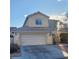 Charming two-story home featuring a two-car garage, neutral stucco, and a tile roof at 5830 Springmist St, North Las Vegas, NV 89031