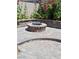 Brick firepit area with a seating area and colorful landscaping at 5830 Springmist St, North Las Vegas, NV 89031