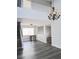 Open-concept living room featuring a staircase, neutral paint, and stylish chandelier at 5830 Springmist St, North Las Vegas, NV 89031