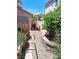 Side yard features a pathway with rock cover and garden area at 5830 Springmist St, North Las Vegas, NV 89031