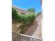 Landscaped side yard with a concrete walkway and rock ground cover at 5830 Springmist St, North Las Vegas, NV 89031