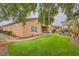 Back exterior featuring a covered patio, and a green artificial grass yard at 6065 Burleson Ranch Rd, Las Vegas, NV 89131