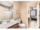 Bathroom with a wood vanity and white countertops, next to the toilet and shower at 6065 Burleson Ranch Rd, Las Vegas, NV 89131