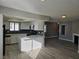 Modern open-concept kitchen featuring white cabinets, granite counters, and stainless steel appliances at 6743 W Charleston Blvd # 4, Las Vegas, NV 89146