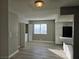 Living area with laundry and bar seating which overlooks the kitchen featuring granite counters and black appliances at 6743 W Charleston Blvd # 4, Las Vegas, NV 89146
