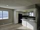 Open kitchen featuring white cabinets, granite counters, subway tile backsplash and black appliances at 6743 W Charleston Blvd # 4, Las Vegas, NV 89146