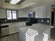 Modern kitchen featuring stainless steel appliances, white cabinetry, and a sleek breakfast bar at 6743 W Charleston Blvd # 4, Las Vegas, NV 89146