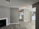 Spacious living room with wood-look tile, fireplace, laundry closet and seamless flow into other spaces at 6743 W Charleston Blvd # 4, Las Vegas, NV 89146