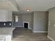 Bright living room features a white fireplace, hardwood floors, and a view to the kitchen at 6743 W Charleston Blvd # 4, Las Vegas, NV 89146