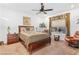 Comfortable bedroom featuring a ceiling fan, natural light, and neutral decor at 6756 Millbury St, North Las Vegas, NV 89086