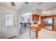 Well-equipped kitchen with stainless steel appliances, wooden cabinets, and granite countertops open to living area at 7724 Clearwood Ave, Las Vegas, NV 89123