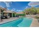 Beautiful backyard featuring a pool with a sun deck, perfect for relaxation and entertaining under a sunny sky at 7724 Clearwood Ave, Las Vegas, NV 89123