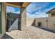 An enclosed backyard patio area with pavers, a stone pillar, and manicured potted plants at 795 Sunny Sagebrush St, Henderson, NV 89011