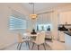 Bright dining area featuring a modern chandelier, stylish curtains, and neutral-toned furniture at 795 Sunny Sagebrush St, Henderson, NV 89011