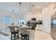 Modern kitchen with stainless steel appliances, black countertops and island seating at 795 Sunny Sagebrush St, Henderson, NV 89011