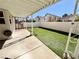 Backyard features a covered patio and artificial grass for easy maintenance at 8461 Faucet Ave, Las Vegas, NV 89147