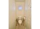 A compact bathroom with a toilet and a decorative glass block window for natural light at 8461 Faucet Ave, Las Vegas, NV 89147