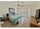 Cozy carpeted bedroom showcasing a comfortable bed, ceiling fan, and natural light filtering through the window at 8461 Faucet Ave, Las Vegas, NV 89147