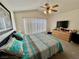 Bedroom with a bed, ceiling fan, and a large window at 8461 Faucet Ave, Las Vegas, NV 89147