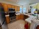 Kitchen features ample cabinet space, stainless steel appliances, and tile countertops at 8461 Faucet Ave, Las Vegas, NV 89147