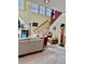 Living room with vaulted ceilings, a staircase, carpet, and plentiful natural light at 8461 Faucet Ave, Las Vegas, NV 89147
