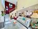 Living room with vaulted ceilings, large windows, a staircase, and an open floor plan at 8461 Faucet Ave, Las Vegas, NV 89147