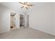 Carpeted bedroom features ceiling fan, ensuite bathroom and closet at 8533 Last Point Ave, Las Vegas, NV 89129