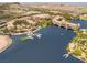 Stunning aerial view of lakefront property featuring a dock, boat slips, and surrounding community at 9 Promenade Isle Ln, Henderson, NV 89011