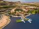 Majestic aerial view of the lake, showcasing the community, a dock with boat slips, and the desert landscape at 9 Promenade Isle Ln, Henderson, NV 89011