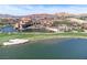 Aerial view highlighting the lakefront golf course and resort with pristine waters and lush greenery at 9 Promenade Isle Ln, Henderson, NV 89011