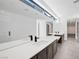 Modern bathroom features dual sinks, dark wood cabinets, and a large mirror at 9 Promenade Isle Ln, Henderson, NV 89011