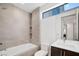 Modern bathroom with a tub, shower, and single sink vanity with light wood cabinets at 9 Promenade Isle Ln, Henderson, NV 89011
