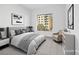 This virtually staged bedroom has neutral tones and a large window for plenty of light at 9 Promenade Isle Ln, Henderson, NV 89011