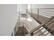 Open foyer and staircase with modern metal railings and a large window at 9 Promenade Isle Ln, Henderson, NV 89011