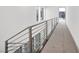 Hallway with gray carpet and a modern metal railing at 9 Promenade Isle Ln, Henderson, NV 89011