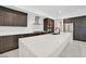 Features include a large island with counter seating, modern stainless steel appliances, and dark wood cabinetry at 9 Promenade Isle Ln, Henderson, NV 89011