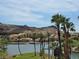 Scenic view of a lakefront community with palm trees and Mediterranean-style buildings at 9 Promenade Isle Ln, Henderson, NV 89011