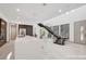 Bright open-concept space with sleek island, modern cabinetry, and staircase with natural light from large windows at 9 Promenade Isle Ln, Henderson, NV 89011