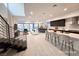 Bright, open living area featuring a modern kitchen, dining space, and comfortable seating, all bathed in natural light at 9 Promenade Isle Ln, Henderson, NV 89011