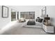 Serene bedroom featuring a king-size bed, neutral decor, a sitting area, and large windows offering natural light at 9 Promenade Isle Ln, Henderson, NV 89011
