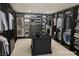Spacious walk-in closet with custom shelving, drawers, and ample storage for clothing and accessories at 9 Promenade Isle Ln, Henderson, NV 89011
